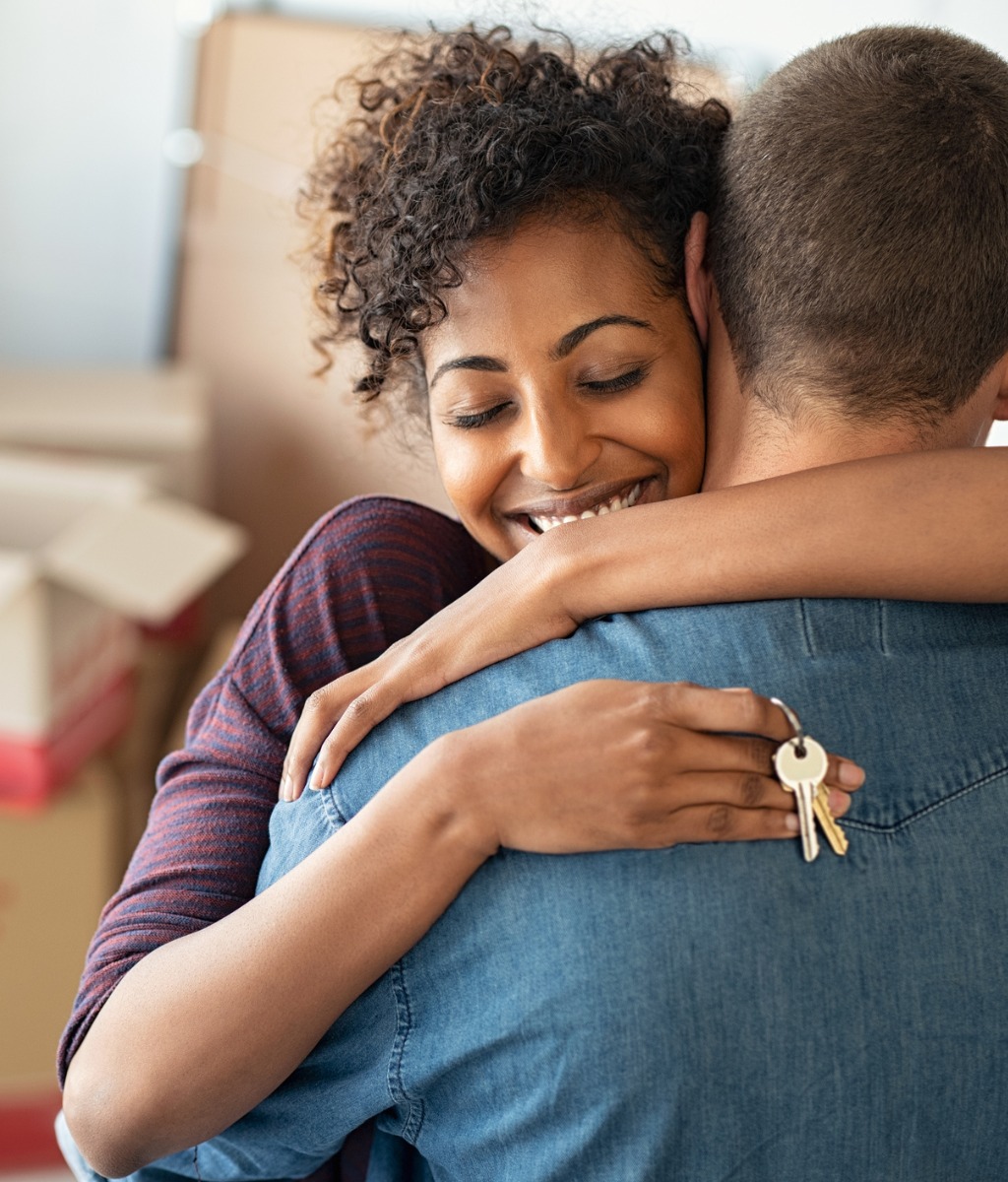 man and woman hugging after buying a new home